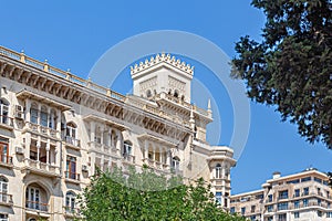 Large beautiful building with square turrets against the sky