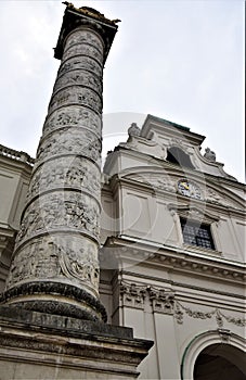 Large and beautiful column, located to the left, of the entrance to the facade of the large church of San Carlo Borromeo in Vienna