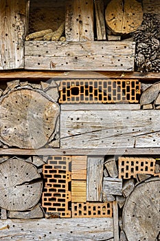 Large and beautiful insect hotel in the corridor near a creek with a tiled roof as protection against rain