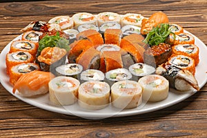 A large beautiful sushi set with maki rolls, nigiri and gunkans