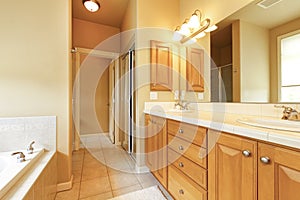 Large beige and wood bathroom interior.