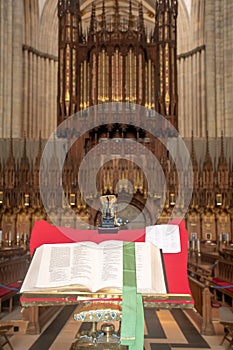 Large Bible open in pulpit with large Church in background