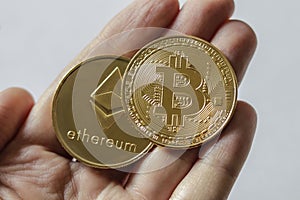 A Large Bitcoin and Etherium Token in hand