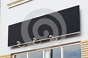 Large black billboard banner on a storefront mockup. Blank black restaurant or shop sign mock up template