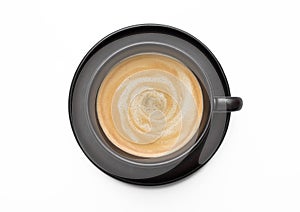 Large black creamy coffee in porcelain cup with saucer on white background. Top view