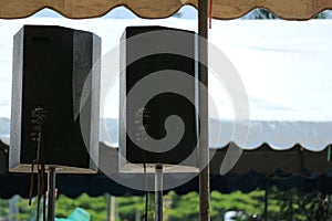Large black event amplification speaker cabinet in a tent photo