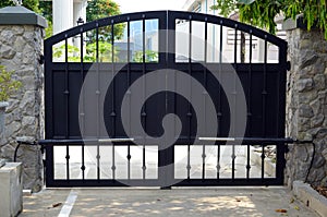 Large black gate with automatic door opening and closing system.