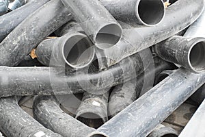 Large black plastic sewer plumbing pipes for the construction of water pipes or sewers at a construction site during the repair.
