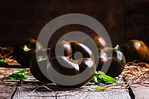 Large black tomatoes, rustic style, selective focus
