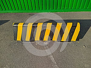 large black and yellow border to prohibit the passage of cars beyond the designated area