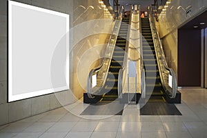 Large blank billboard at the escalator entrance to the mall