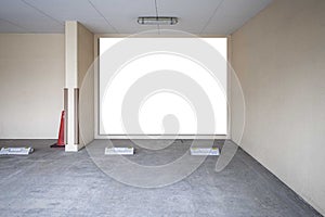 Large blank billboard on the wall of the basement