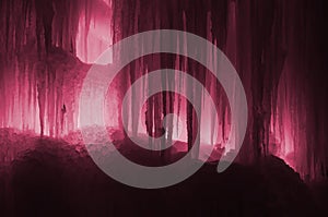 Large blocks of ice frozen waterfall or cavern background Image toned in Viva Magenta, color of the 2023 year