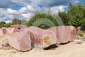 Large blocks of red granite with flat and torn edges