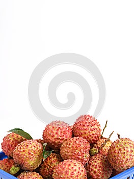 a large blue basket filled with fruit on a table next to a small cup