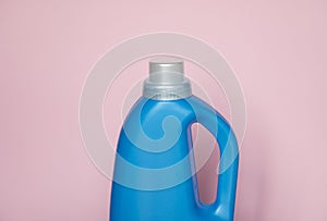 Large blue plastic bottle with gel for washing isolated on a pink background. Laundry container, merchandise template.