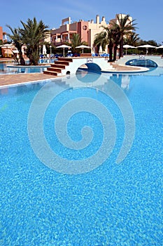 Large, blue swimming pool in luxurious Spanish complex