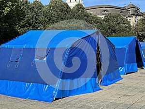 Large blue tent on the street in the city