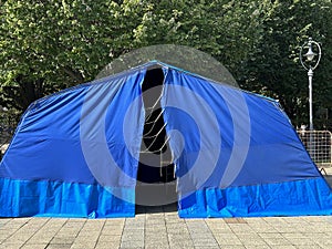 Large blue tent on the street in the city