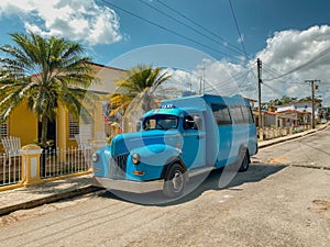 Large blue vintage truck parked outside a house in Vinales, Cuba. Many vintage vehicles are restored, converted into colectivos photo