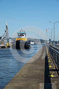 Large blue and yellow tugboat at Ballard Locks, Seattle