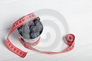 Large blueberries in a decorative bucket. International day without diets. On a white background. Close-up