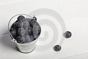 Large blueberries in a decorative bucket. International day without diets. On a white background. Close-up