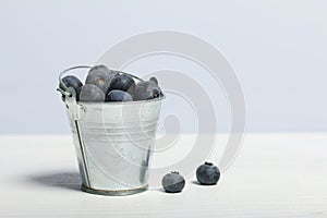 Large blueberries in a decorative bucket. International day without diets. On a white background. Close-up