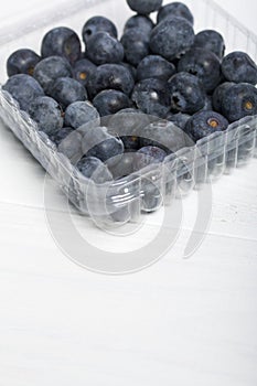 Large blueberries in a decorative container. International day without diets. On a white background. Close-up