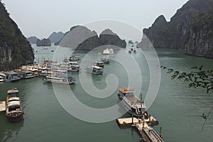 A large body of sea with many boats floating on it in Ha Long Bay Hanoi Vietnam photo