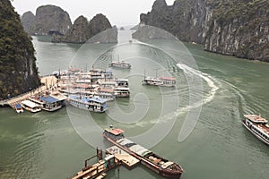 A large body of water with many boats docked at a pier in Ha Long Bay Hanoi Vietnam photo