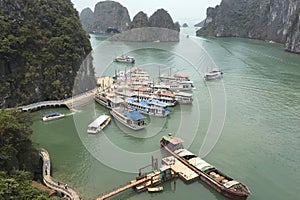 A large body of water with many boats docked at a pier in Ha Long Bay Hanoi Vietnam photo