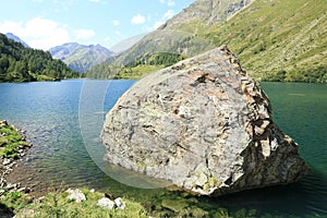 Large boulder in mountain lake