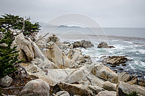 Large boulders along the rocky coastline of California near Monterey and Big Sur, on a gloomy overcast day