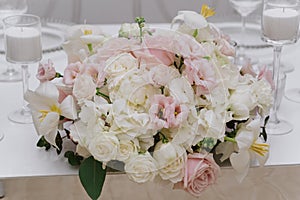 A large bouquet of light and pastel shades on the groom and bride `s table. Beautiful white, pink fresh flowers