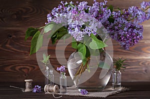 A large bouquet of lilacs on the table. Still life.