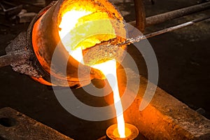 large bowl of molten metal at a steel mill. Steel production