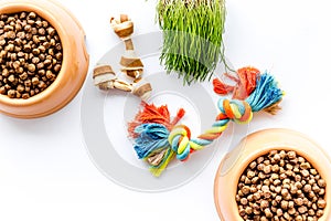 Large bowl of pet - dog food with toys on white background top view mockup