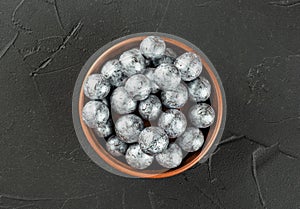 Large bowl with silver candies hazelnuts in chocolate