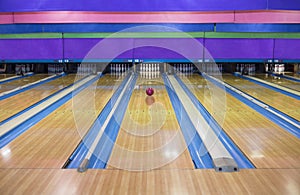 Large Bowling Alley with a ball rolling down the lane