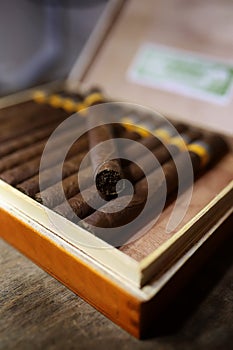 Large box of Cuban cigars on a wooden table