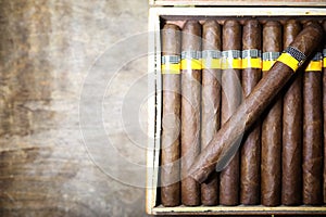 Large box of Cuban cigars on a wooden table