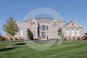 Large brick home with red door