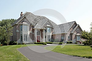 Large brick home with red door