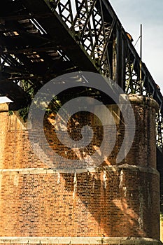 A large brick and stone masonry arch bridge over the Kuala Kangsar river in Malaysia