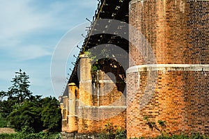 A large brick and stone masonry arch bridge over the Kuala Kangsar river in Malaysia