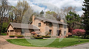 Large Brick Two-car Garage Home with Flowering Crabapple Trees