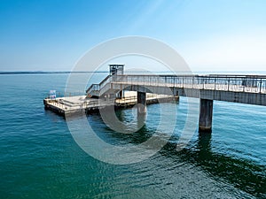 A large bridge with a pier and jumping and walking people in Burgas, Bulgaria