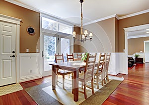 Large bright beige dining room with cherry hardwood.