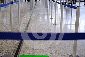 Large bright hall of the Frankfurt am Main Airport in general, passenger check-in terminal, blue ribbons direct to baggage control